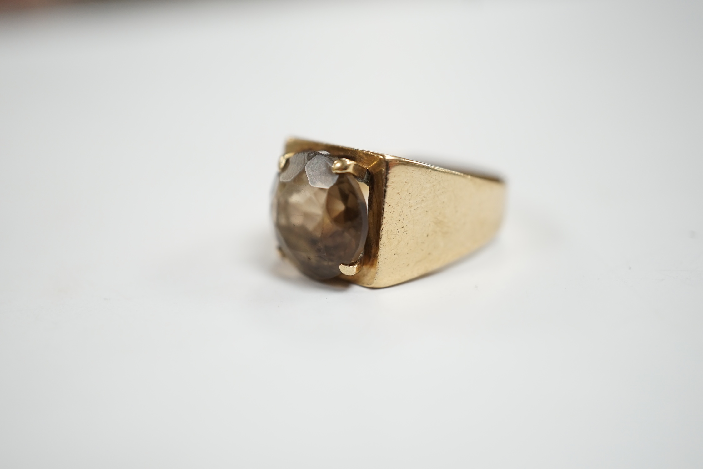 A 9ct gold and single stone oval cut smoky cut quartz set ring, size H, gross weight 4.5 grams.